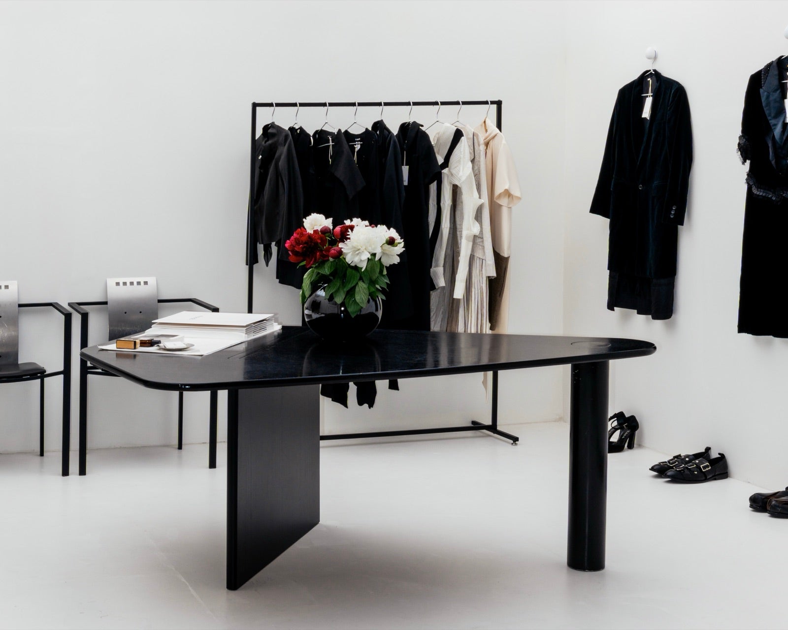 A wide view across archive garments and rails inside the Mondō studio.
